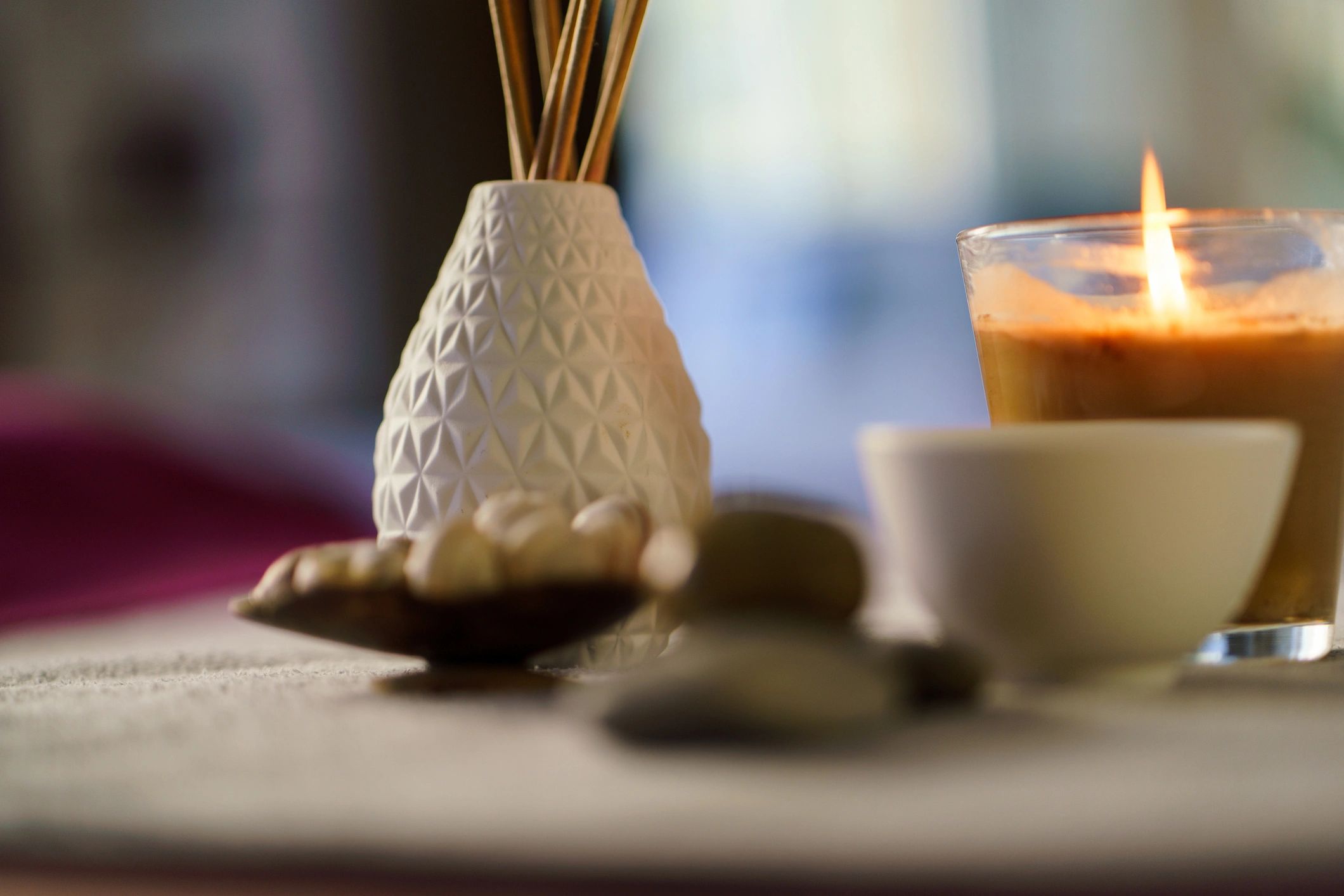 Warm home fragrance scene with candle and diffuser